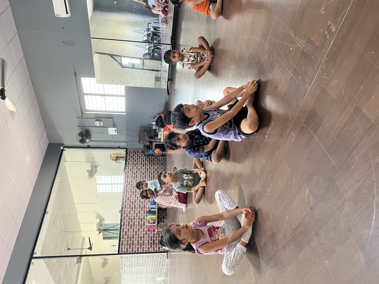 Children gathered in the bright movement room for yoga and circle time