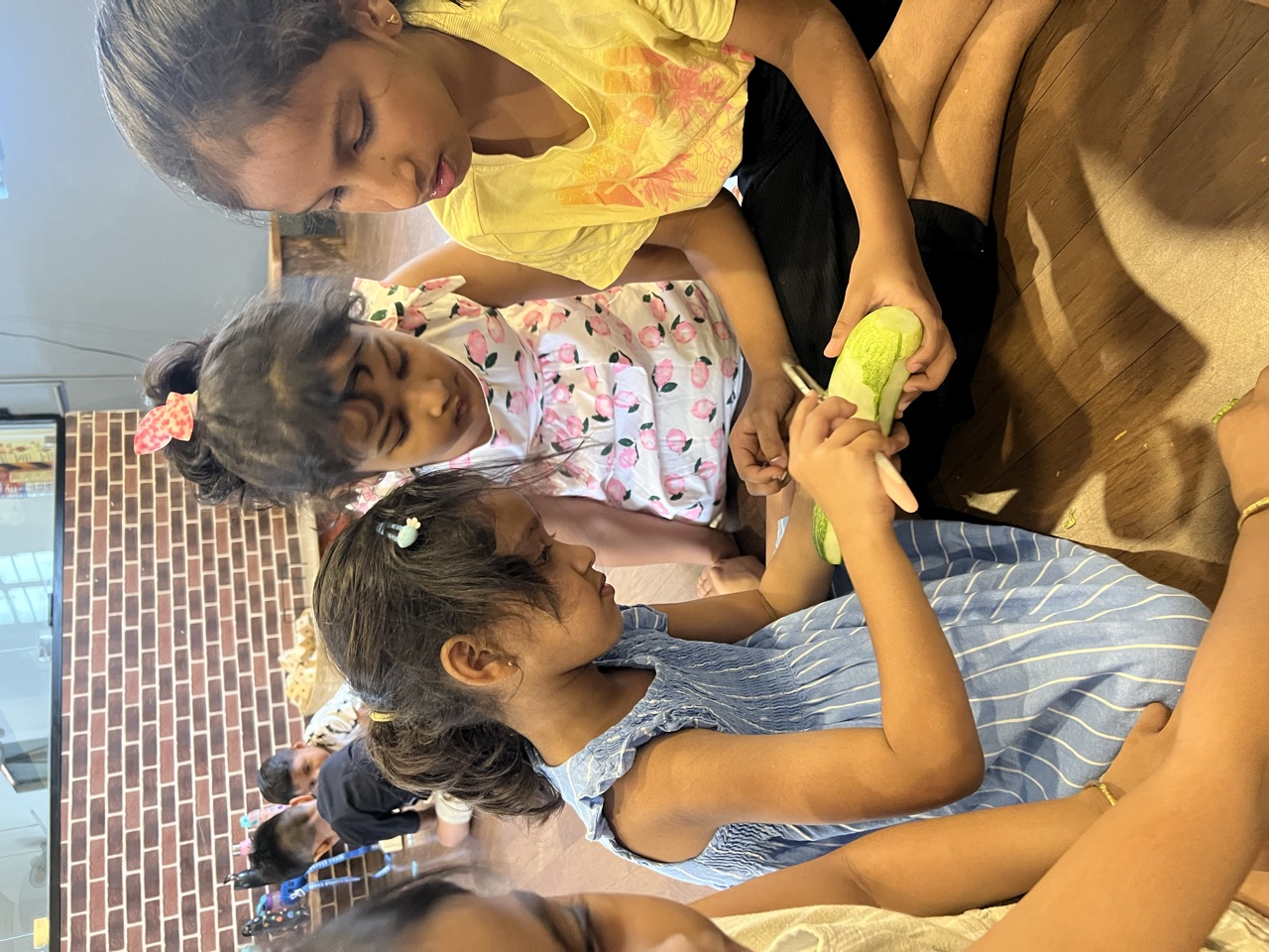 Children working together to peel fresh corn